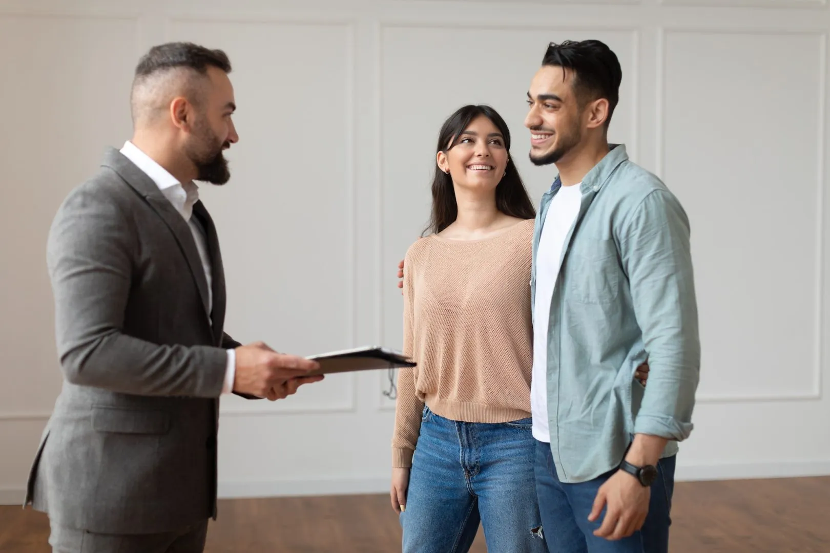 Estate Agent Showing Property For Young Buyers